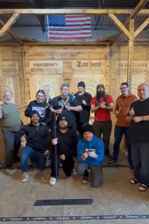 Group posing together during an axe-throwing outing